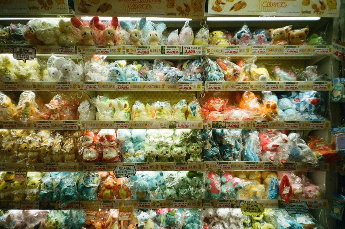 Plush toys displayed on store shelves — authorized retailers carry authentic products